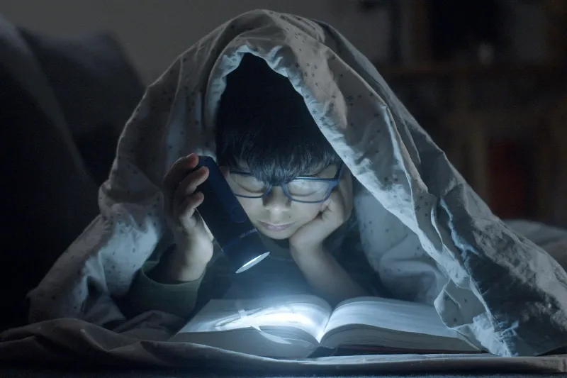 Reading in the Dark Won't Ruin Your Eyes — That Warning Came From Parents Who Just Wanted Bedtime to Stick